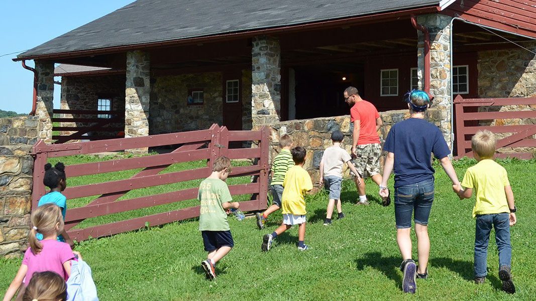 Summer Camp at Coverdale Farm Instructor and Kids by Barn